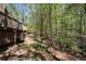 Exterior view of home shows multi-level decks and wooded surroundings at 2235 Six Branches Dr, Roswell, GA 30076
