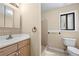Bathroom featuring a vanity sink, a standard toilet, and a tiled shower at 2235 Six Branches Dr, Roswell, GA 30076
