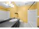 Bright yellow bathroom with a dark granite countertop and vanity, featuring a tub and shower combination at 2235 Six Branches Dr, Roswell, GA 30076