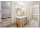Well-lit bathroom with vanity, a walk-in closet, and separate shower area at 2235 Six Branches Dr, Roswell, GA 30076