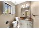 This half-bathroom features a marbled countertop, lighting and a shuttered window for privacy at 2235 Six Branches Dr, Roswell, GA 30076