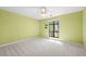 This cozy bedroom features bright yellow walls, carpet and natural light from the outdoor view at 2235 Six Branches Dr, Roswell, GA 30076