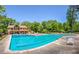 A community pool and clubhouse offers residents a place to relax and unwind surrounded by lush greenery at 2235 Six Branches Dr, Roswell, GA 30076
