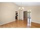 Cozy dining room with elegant chandelier, hardwood flooring, and convenient kitchen access at 2235 Six Branches Dr, Roswell, GA 30076