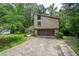 Two-story home with a two-car garage, a front yard, and mature trees at 2235 Six Branches Dr, Roswell, GA 30076