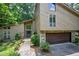 Charming home with a striking exterior, a stone-accented garage and a landscaped pathway at 2235 Six Branches Dr, Roswell, GA 30076