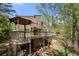 Expansive wooden decks complement the home's beautiful wooded surroundings at 2235 Six Branches Dr, Roswell, GA 30076