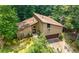 A two-story home with a two-car garage, a front yard, and mature trees at 2235 Six Branches Dr, Roswell, GA 30076