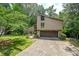 Two-story home with a two-car garage, a front yard, and mature trees at 2235 Six Branches Dr, Roswell, GA 30076