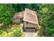 A two-story home with a two-car garage, a front yard, and mature trees at 2235 Six Branches Dr, Roswell, GA 30076