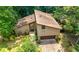 A two-story home with a two-car garage, a front yard, and mature trees at 2235 Six Branches Dr, Roswell, GA 30076
