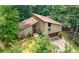 Exterior shot of a multi-story home with a two-car garage, surrounded by lush trees and greenery at 2235 Six Branches Dr, Roswell, GA 30076