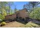 Charming two-story home with a lush green lawn, mature trees, and a private driveway at 2235 Six Branches Dr, Roswell, GA 30076