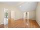 Large living room with hardwood floors and view of trees at 2235 Six Branches Dr, Roswell, GA 30076
