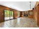 A naturally lit living room with tiled flooring, a stone fireplace, and access to a deck at 2235 Six Branches Dr, Roswell, GA 30076