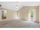 Bright main bedroom with vaulted ceiling, door to deck, and carpeted floors at 2235 Six Branches Dr, Roswell, GA 30076