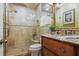 Elegant bathroom with tiled shower, granite vanity, decorative fixtures and tiled floor at 4084 Columns Dr, Marietta, GA 30067