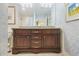 Bathroom vanity with double sinks, granite countertop, and dark wood cabinets at 4084 Columns Dr, Marietta, GA 30067