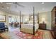 Spacious bedroom with ceiling fan, four poster bed, and an adjacent sitting area at 4084 Columns Dr, Marietta, GA 30067