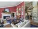 Spacious living room with red accent wall, fireplace, and comfortable seating arrangement at 4084 Columns Dr, Marietta, GA 30067