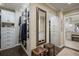 Bright walk-in closet with custom shelving, drawers, wooden stools, and elegant mirror at 4084 Columns Dr, Marietta, GA 30067