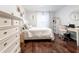 Light-filled bedroom with hardwood floors, white walls, and a desk area at 1005 Brighton Pt, Atlanta, GA 30328