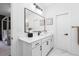 Bright bathroom featuring a large mirror, white cabinets, and marble floors at 1084 Brookglynn Trce, Decatur, GA 30032