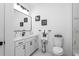 Bright bathroom with sleek fixtures, white cabinetry, and marble floors at 1084 Brookglynn Trce, Decatur, GA 30032