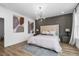 Bright bedroom with modern decor, grey accent wall and light wood floors at 1084 Brookglynn Trce, Decatur, GA 30032