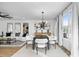 Bright dining room adjacent to the living room featuring modern lighting and neutral decor at 1084 Brookglynn Trce, Decatur, GA 30032