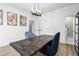 Elegant dining area with a modern table, chairs, and view into a bright bathroom at 1084 Brookglynn Trce, Decatur, GA 30032