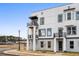 Stylish townhome featuring a contemporary design with balconies, contrasted by a clear blue sky at 1084 Brookglynn Trce, Decatur, GA 30032