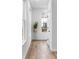 Hallway with hardwood floors, a modern plant stand, and plenty of natural light at 1084 Brookglynn Trce, Decatur, GA 30032