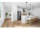 Open concept kitchen with stainless steel appliances, an island with barstool seating, and modern pendant lighting at 1084 Brookglynn Trce, Decatur, GA 30032