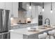 Bright modern kitchen with stainless appliances, center island with seating, and decorative pendant lighting at 1084 Brookglynn Trce, Decatur, GA 30032