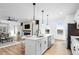 Modern kitchen featuring an island, stainless steel appliances, an adjacent living area, and a dining area at 1084 Brookglynn Trce, Decatur, GA 30032