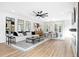 Open-concept living room featuring contemporary decor, a ceiling fan, and a connected dining area at 1084 Brookglynn Trce, Decatur, GA 30032