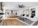 Bright living room featuring a modern ceiling fan, an electric fireplace, and an open floor plan to the kitchen at 1084 Brookglynn Trce, Decatur, GA 30032