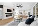 Bright living room featuring an electric fireplace, flat screen tv, modern fan, and an open floor plan at 1084 Brookglynn Trce, Decatur, GA 30032