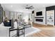 Spacious open-concept living room with modern fireplace, adjacent dining room, and sleek decor at 1084 Brookglynn Trce, Decatur, GA 30032