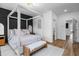 Main bedroom with four poster bed, light wood floors and access to private bath at 1084 Brookglynn Trce, Decatur, GA 30032