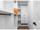 Bright walk-in closet providing ample storage with custom shelves and drawer units at 1084 Brookglynn Trce, Decatur, GA 30032