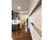 View of the hallway with dark wood floors and decorative shelves against a light gray wall at 3615 Faulkner St, Cumming, GA 30041