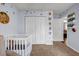 Cozy Bedroom with a crib and closet, decorated with animal prints and leafy decals at 637 Delay Way, Stockbridge, GA 30281