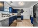 Modern kitchen with stainless steel appliances, blue cabinets, and ample counter space at 637 Delay Way, Stockbridge, GA 30281