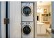 A compact bathroom featuring a stacked washer and dryer setup at 3655 Habersham Ne Rd # 344, Atlanta, GA 30305