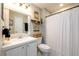 Clean bathroom showcasing a vanity, toilet, and shower with a decorative curtain at 3655 Habersham Ne Rd # 344, Atlanta, GA 30305