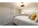 Cozy bedroom featuring neutral walls, gray carpeting, a decorative ceiling fan, and a half-wall at 3655 Habersham Ne Rd # 344, Atlanta, GA 30305