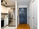 Functional entryway with coat closet, black door, stainless fridge, and white cabinets at 3655 Habersham Ne Rd # 344, Atlanta, GA 30305