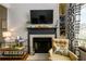 Elegant fireplace with mantel, TV, adjacent to window and chair at 3655 Habersham Ne Rd # 344, Atlanta, GA 30305